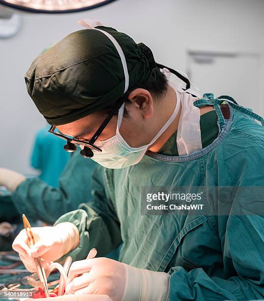 cardiac surgeon while doing open heart surgery - surgical loupes stock pictures, royalty-free photos & images