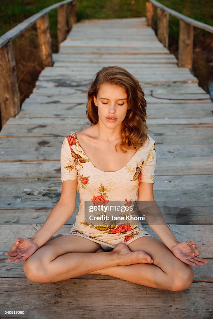 Young woman athlete doing yoga exercise