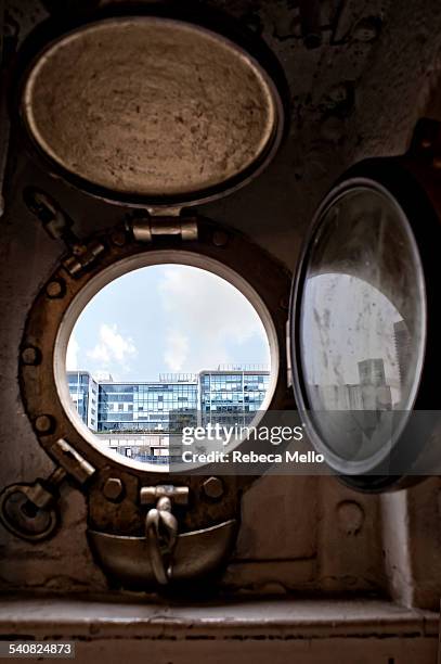 Looking through the window of Fragata Sarmiento Ship Museum, moored in the Rio de la Plata. It is seen a part of the modern buildings of Puerto...