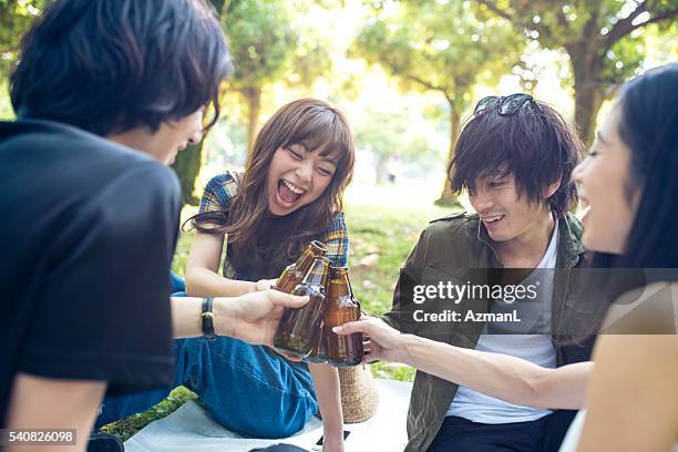 beer with best friends - man sipping beer smiling stockfoto's en -beelden