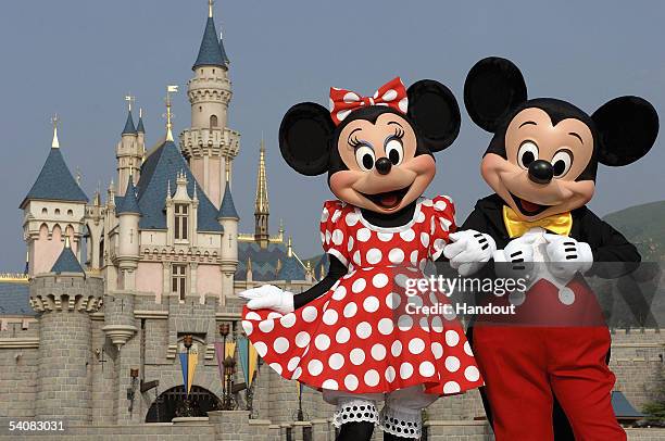 In this handout photo provided by Disney, Mickey and Minnie Mouse are seen in front of the Sleeping Beauty Castle at the new Disneyland Park on...