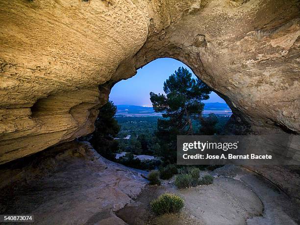 interior during the night  of the cave,  cueva horadada, " the perforated one " placed in the mount arabí. heritage of the humanity. unesco - pinnacle rock formation fotografías e imágenes de stock