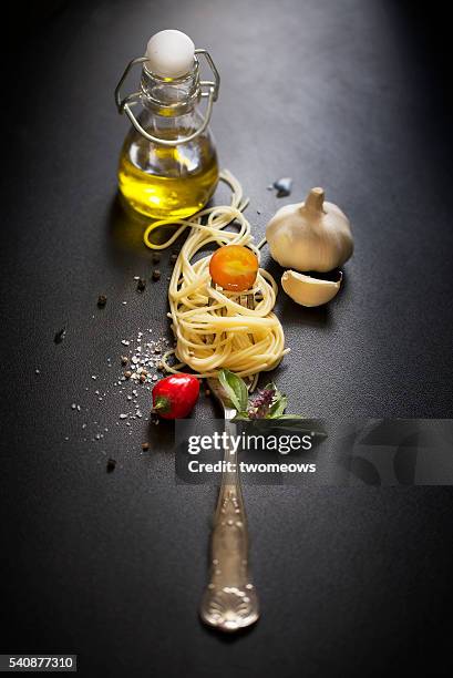 italian food, spaghetti recipe ingredient on black texture background. - chili oil stock pictures, royalty-free photos & images