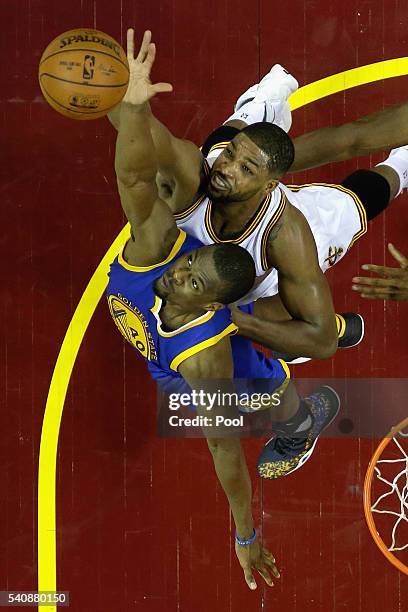 Harrison Barnes of the Golden State Warriors and Tristan Thompson of the Cleveland Cavaliers battle for the ball during the first half in Game 6 of...