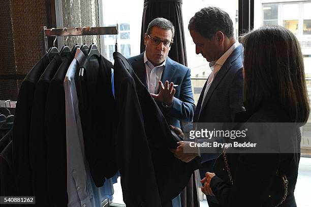 Guests look at clothes at the Kenneth Cole Awearness exclusively for the Mens Wearhouse display at the 37.5/Cocona Brand showcase event at Gansevoort...