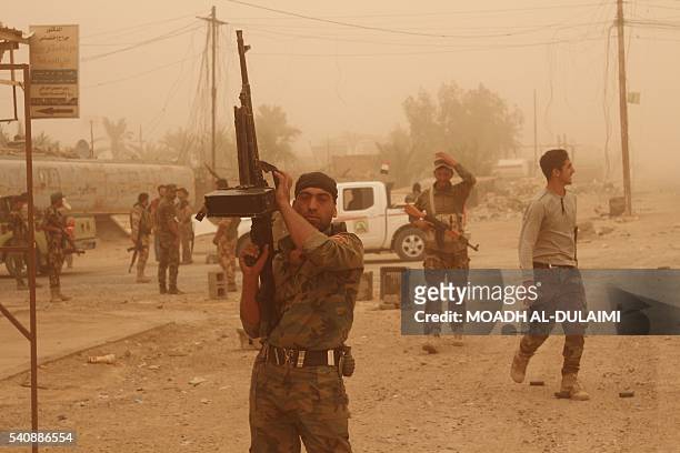 Iraqi government forces are seen on June 16, 2016 after recapturing the town of Zankura, northwest of Ramadi in Anbar province, from the Islamic...