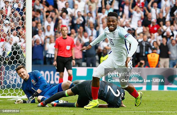 Daniel Sturridge of England celebrates scoring the winning goal as Wayne Hennessey and Chris Gunter of Wales look dejected during the UEFA EURO 2016...