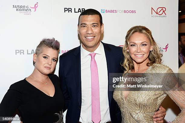 Personality Kelly Osbourne, comedian/actor Michael Yo, and dancer Kym Johnson attend the Babes for Boobs Bachelor Auction benefitting the Los Angeles...