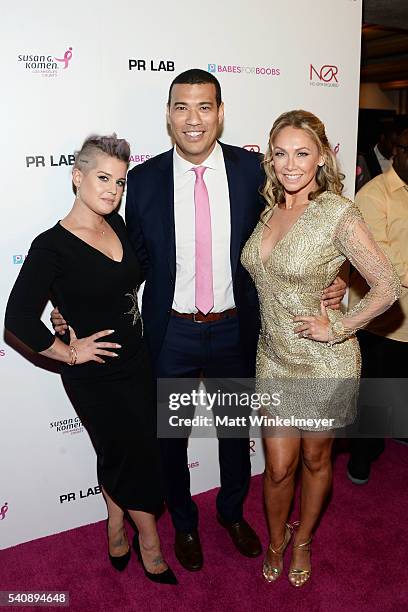 Personality Kelly Osbourne, comedian/actor Michael Yo, and dancer Kym Johnson attend the Babes for Boobs Bachelor Auction benefitting the Los Angeles...