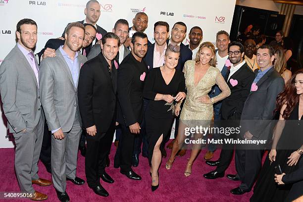 Personality Kelly Osbourne and dancer Kym Johnson pose for a photo with the participating Bachelors during the Babes for Boobs Bachelor Auction...