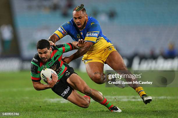 Cody Walker of the Rabbitohs is tackled by Kenny Edwards of the Eels during the round 15 NRL match between the South Sydney Rabbitohs and the...