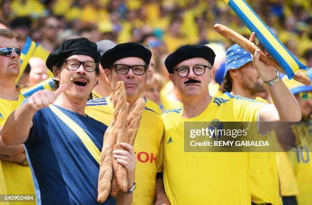 Sweden fans sporting berets and holding baguettes pose as they wait for the start of the Euro 2016 group E football match between Italy and Sweden at...