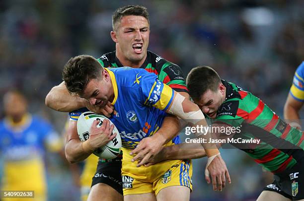 Clinton Gutherson of the Eels is tackled by Sam Burgess of the Rabbitohs during the round 15 NRL match between the South Sydney Rabbitohs and the...