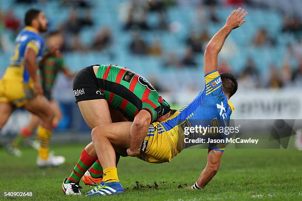 Corey Norman of the Eels is tackled by Sam Burgess of the Rabbitohs during the round 15 NRL match between the South Sydney Rabbitohs and the...