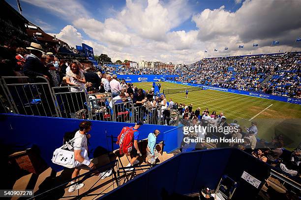 Andy Murray and Kyle Edmund of Great Britain make their way out to centre court ahead of their quarter final match on day five of The Aegon...