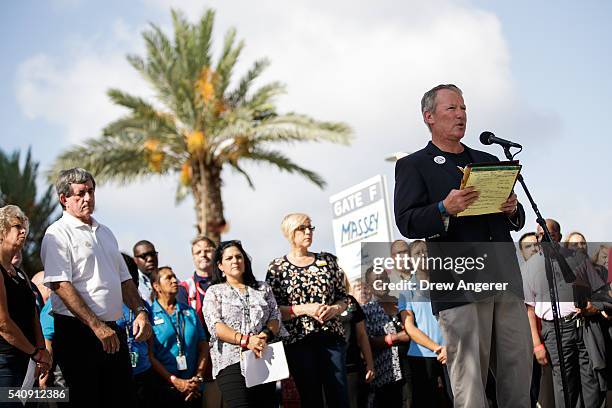 Surrounded by members of federal, state and local agencies, Orlando Mayor Buddy Dyer speaks at a press conference to provide an update on the...