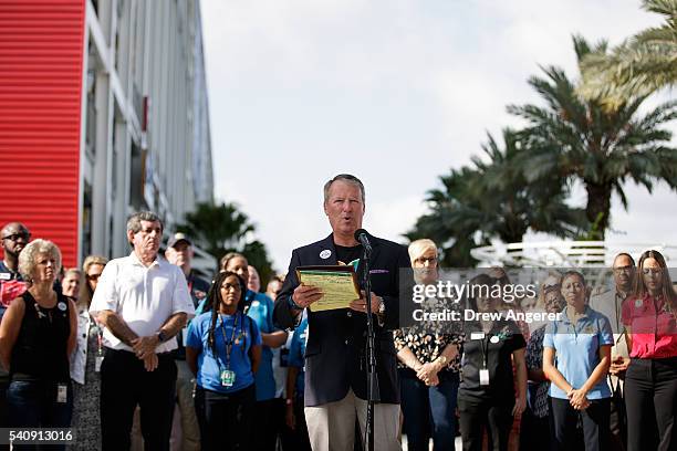 Surrounded by members of federal, state and local agencies, Orlando Mayor Buddy Dyer speaks at a press conference to provide an update on the...