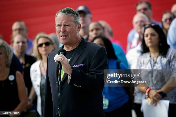 Surrounded by members of federal, state and local agencies, Orlando Mayor Buddy Dyer speaks at a press conference to provide an update on the...