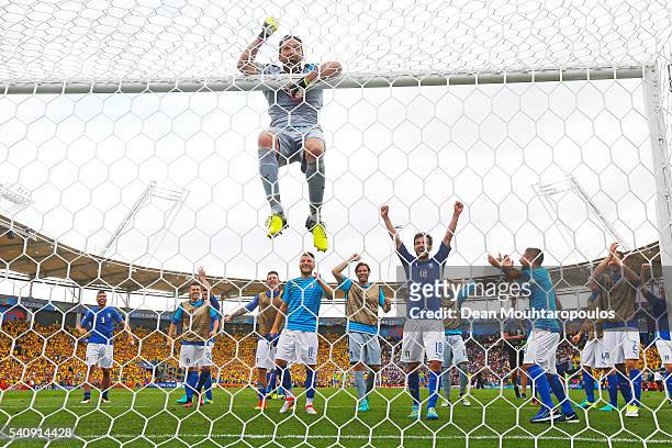 Gianluigi Buffon of Italy hangs from the crossbar as the Italian team celebrate victory in the UEFA EURO 2016 Group E match between Italy and Sweden...