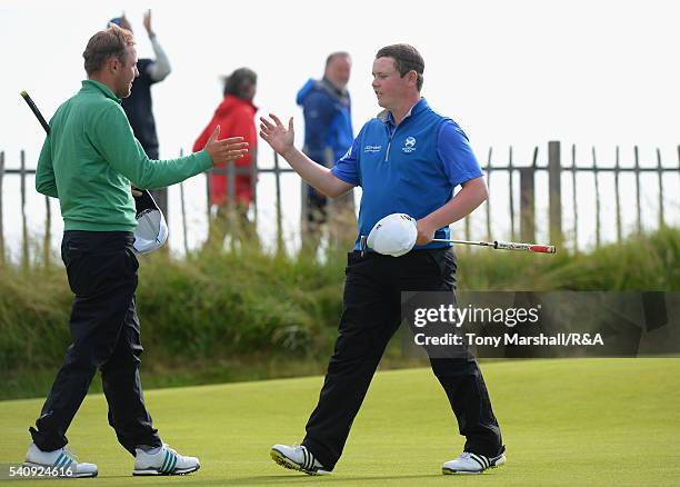 Robert MacIntyre of Glencruitten shakes hands with Paul McBride of The Island after winning their semi-final match during The Amateur Championship...