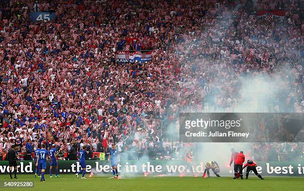 Flairs are thrown onto the pitch during the UEFA EURO 2016 Group D match between Czech Republic and Croatia at Stade Geoffroy-Guichard on June 17,...