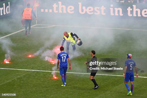 Flairs are thrown onto the pitch during the UEFA EURO 2016 Group D match between Czech Republic and Croatia at Stade Geoffroy-Guichard on June 17,...