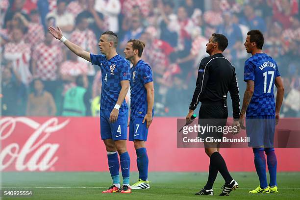 Ivan Perisic of Croatia reacts to supporters who have thrown a flare onto the pitch during the UEFA EURO 2016 Group D match between Czech Republic...