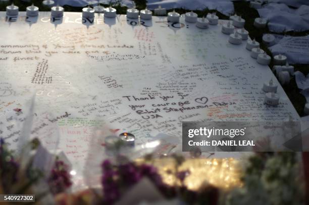 Message board, candles and flowers are laid as tributes in remembrance of slain Labour MP Jo Cox in Parliament square in front of the Houses of...