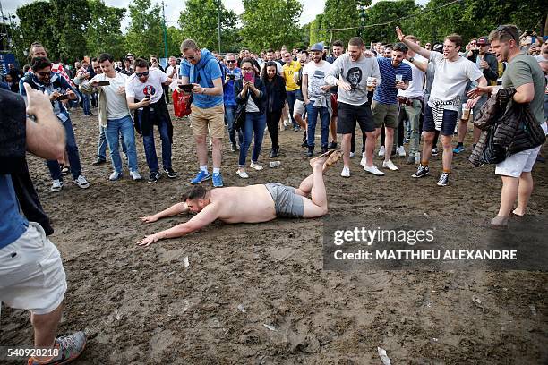 Man slips in the mud as football fans watch the Euro 2016 group D football match between the Czech Republic and Croatia on a giant screen at the fan...