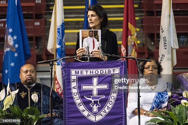 South Carolina Governor Nikki Haley holds up a photo of Clementa Pinckney during a memorial service remembering the victims of the mass shooting at...