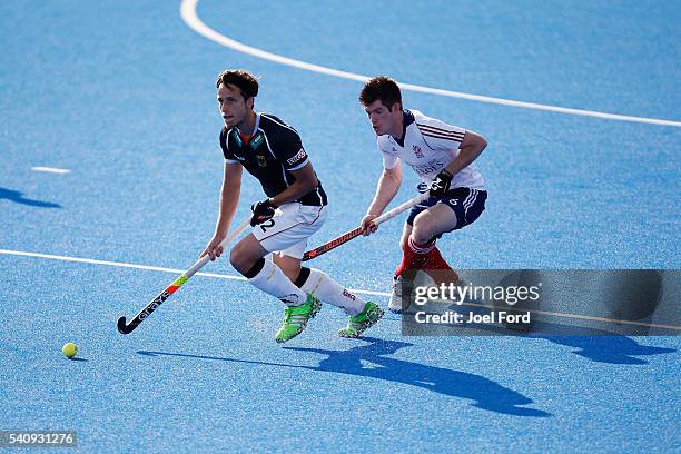 Timm Herzbruch of Germany carries the ball carries past Henry Weir of Great Britain during the FIH Men's Hero Hockey Champions Trophy match between...