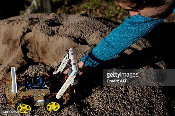 Argentinian industrial engeneering student of the National University of Cuyo, Marcos Bruno, shows a robot made by him, in Mendoza, Argentina on June...