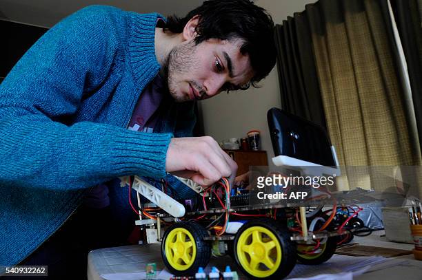 Argentinian industrial engeneering student of the National University of Cuyo, Marcos Bruno, works on a robot made by him, in Mendoza, Argentina on...