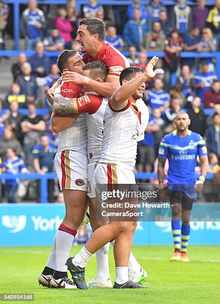 Julian Bousquet of Catalan Dragons is congratulated on scoring his sides 1st try during the First Utility Super League Round 19 match between...