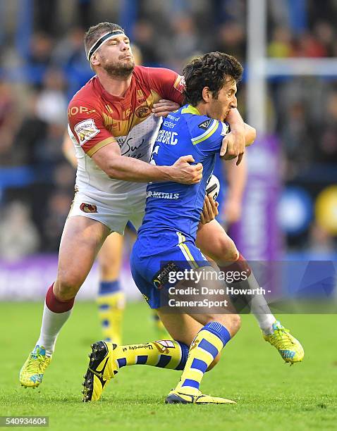 Stefan Ratchford of Warrington Wolves is tackled by Remi Casty of Catalan Dragons during the First Utility Super League Round 19 match between...