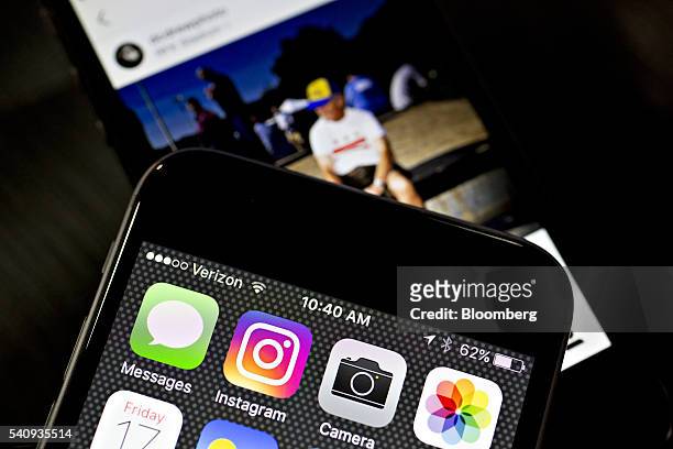 Facebook Inc.'s Instagram logo is displayed on an Apple Inc. IPhone in this arranged photograph taken in Washington, D.C., U.S., on Friday, June 17,...
