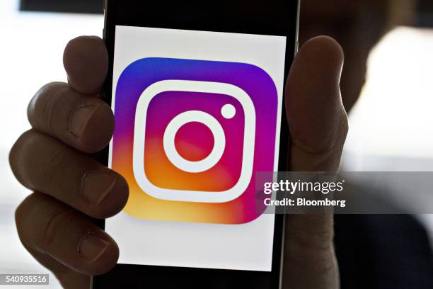 Facebook Inc.'s Instagram logo is displayed on an Apple Inc. IPhone in this arranged photograph taken in Washington, D.C., U.S., on Friday, June 17,...