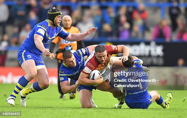 Julian Bousquet of Catalan Dragons is brought down during the First Utility Super League Round 19 match between Warrington Wolves and Catalans...