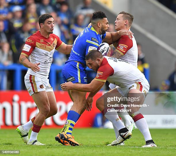 Ryan Atkins of Warrington Wolves is tackled by Todd Carney of Catalan Dragons during the First Utility Super League Round 19 match between Warrington...