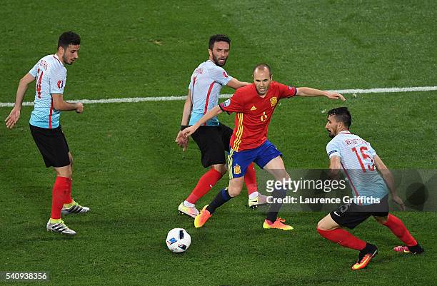 Gokhan Gonul, Mehmet Topal and Oguzhan Ozyakup of Turkey surround Andres Iniesta of Spain during the UEFA EURO 2016 Group D match between Spain and...