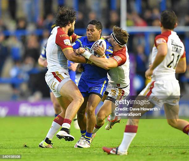 Chris Sandow of Warrington Wolves is tackled by Antoni Maria and Thibaut Margalet of Catalan Dragons during the First Utility Super League Round 19...