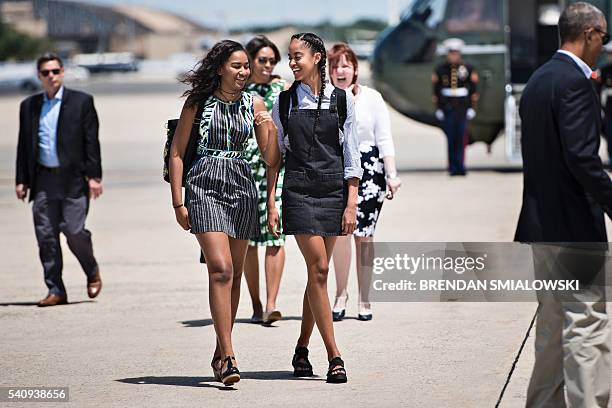 Sasha Obama , US first lady Michelle Obama and Malia Obama follow US President Barack Obama to Air Force One at Andrews Air Force Base to travel to...