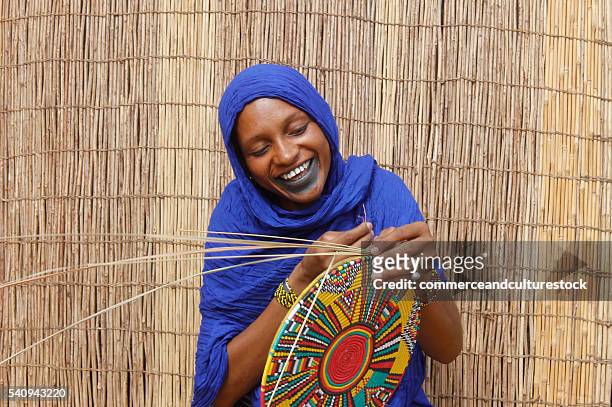 a fulani woman firing a van - futa stockfoto's en -beelden