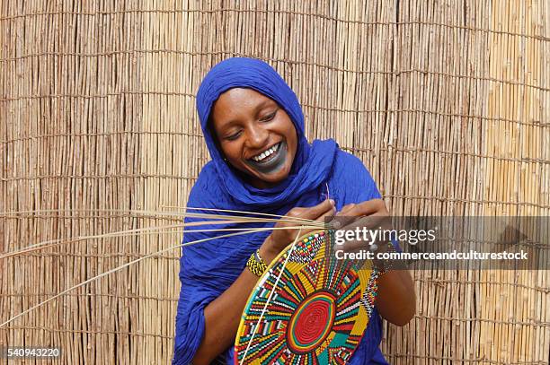 a fulani woman firing a van - commerceandculturestock stock pictures, royalty-free photos & images