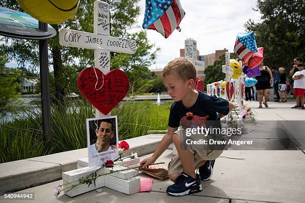 Donovan Spurlock places flowers at each of the wooden crosses that were made for the 49 victims of the Pulse Nightclub shooting, next to the Orlando...