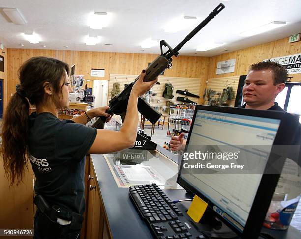 Courtney Manwaring, shows an AR-15 semi-automatic gun to David Barker at Action Target on June 17, 2016 in Springville, Utah. Semi-automatics are in...