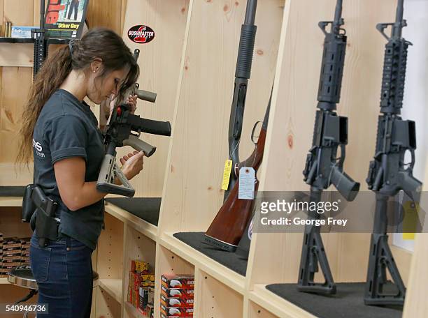 Courtney Manwaring puts away an AR-15 semi-automatic gun at Action Target on June 17, 2016 in Springville, Utah. Semi-automatics are in the news...