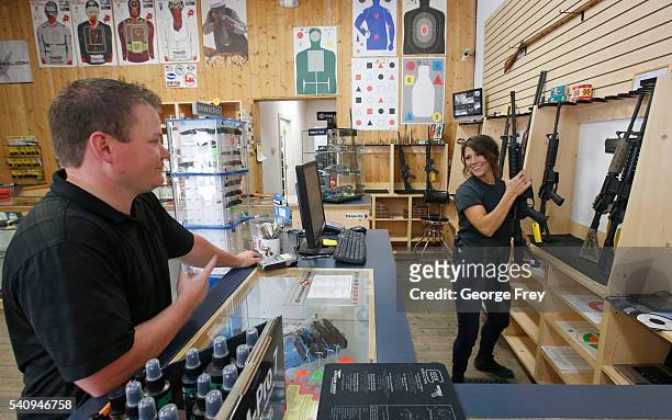 Courtney Manwaring, shows an AR-15 semi-automatic gun to David Barker at Action Target on June 17, 2016 in Springville, Utah. Semi-automatics are in...