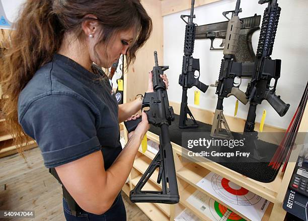 Courtney Manwaring looks over an AR-15 semi-automatic gun at Action Target on June 17, 2016 in Springville, Utah. Semi-automatics are in the news...