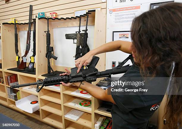 Courtney Manwaring looks over an AR-15 semi-automatic gun at Action Target on June 17, 2016 in Springville, Utah. Semi-automatics are in the news...
